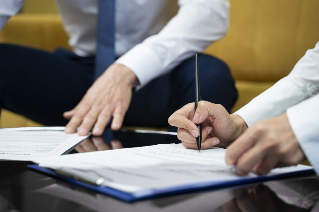 Business professionals reviewing and signing compliance documents before 7-OH merchant account deadlines