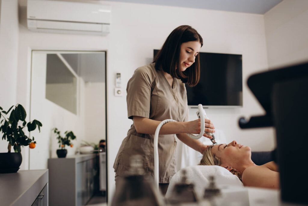 beautician-makes-young-beautiful-girl-vacuum-facial-treatment-rejuvenation-girl-is-undergoing-course-spa-treatments-office-beautician