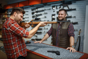 man-aims-with-new-rifle-seller-counter-gun-shop-male-person-buying-weapon-store-hunting-sport-shooting-hobby