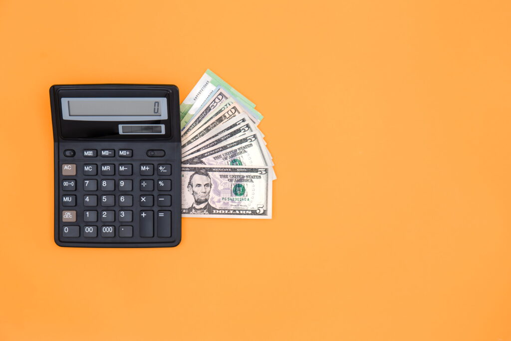 calculator-dollar-bills-orange-background-copy-space