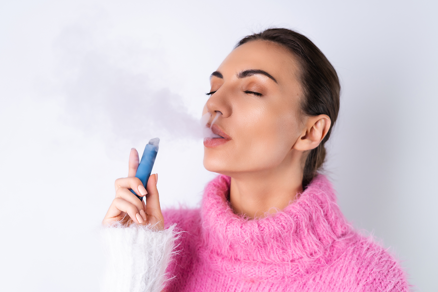 young-cheerful-girl-bright-colored-sweater-white-background-enjoys-electronic-disposable-cigarette-with-her-eyes-closed-smokes-releases-smoke
