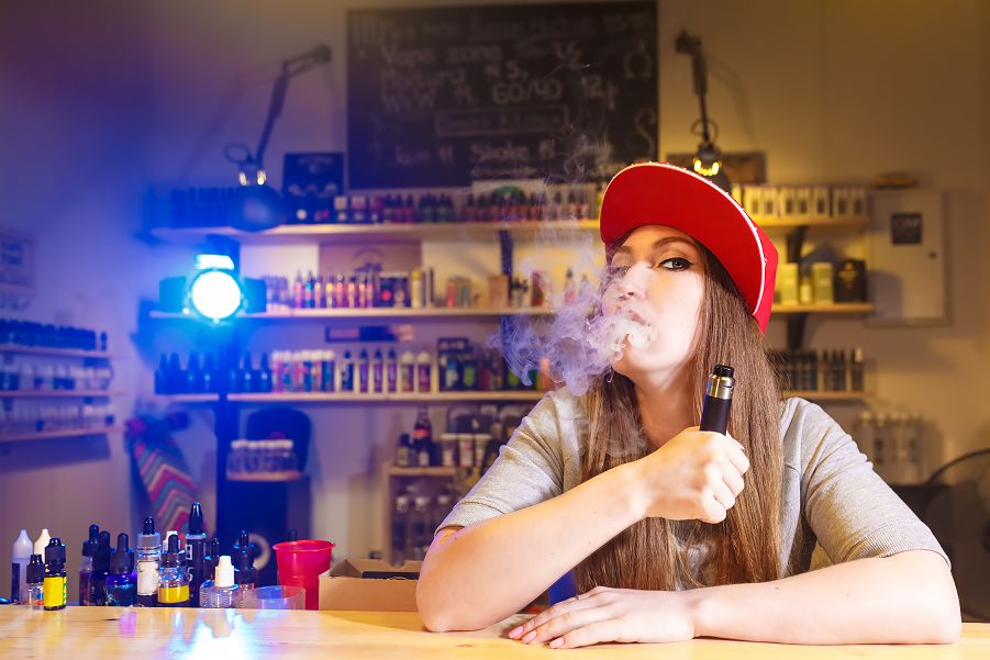 young-pretty-woman-red-cap-smoke-electronic-cigarette-vape-shop