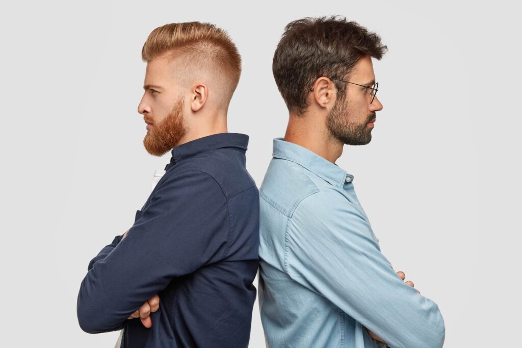 indoor-view-serious-two-partners-stand-back-have-some-disagreement-keeps-hands-folded