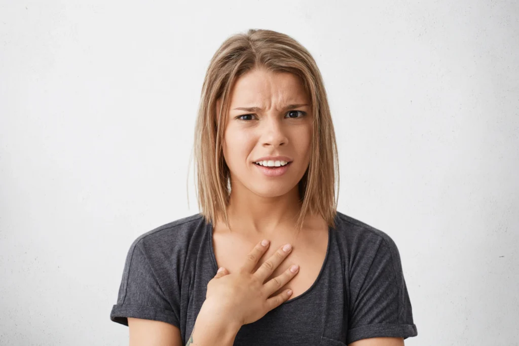 young-female-with-bob-haircut-pointing-herself-with-hand-feeling-confused